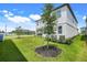 View of the home's well-manicured backyard with healthy lawn and landscaping at 2161 Gold Dust Dr, Minneola, FL 34715
