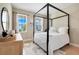 Comfortable bedroom features a canopy bed and views of the outdoors at 2161 Gold Dust Dr, Minneola, FL 34715