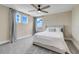 Comfortable bedroom with neutral walls, carpet, ceiling fan and two windows providing natural light at 2161 Gold Dust Dr, Minneola, FL 34715
