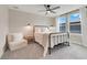 Bedroom with a black metal bed frame, large windows, and a comfy chair at 2161 Gold Dust Dr, Minneola, FL 34715