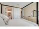 Bedroom featuring a canopy bed and ensuite bath with ample natural light at 2161 Gold Dust Dr, Minneola, FL 34715