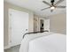Neutral bedroom featuring a black metal bed frame and bright white doors at 2161 Gold Dust Dr, Minneola, FL 34715