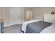 Neutral bedroom featuring a bed and a large white dresser at 2161 Gold Dust Dr, Minneola, FL 34715