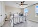 A bedroom with light beige walls, carpet flooring, a ceiling fan and a metal bed frame at 2161 Gold Dust Dr, Minneola, FL 34715