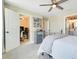 Bedroom view with carpet, a metal bed, open doors, and neutral walls at 2161 Gold Dust Dr, Minneola, FL 34715