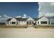 A modern, white farmhouse-style clubhouse with large windows and ample parking at 2161 Gold Dust Dr, Minneola, FL 34715
