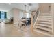 Open concept dining room adjacent to stairs offers natural light and wood-look tile floors at 2161 Gold Dust Dr, Minneola, FL 34715