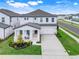 Desirable home with inviting front porch, two rocking chairs, and manicured lawn at 2161 Gold Dust Dr, Minneola, FL 34715