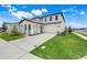 Well-maintained two-story home with a covered front porch, two-car garage, and green lawn at 2161 Gold Dust Dr, Minneola, FL 34715