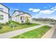Attractive new home with covered porch, manicured lawn and close sidewalk access at 2161 Gold Dust Dr, Minneola, FL 34715