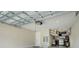 Spacious garage with overhead storage racks, door opener and clean epoxy flooring at 2161 Gold Dust Dr, Minneola, FL 34715