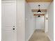 Bright hallway features modern lighting, wooden beams, and light wood-look tile floors at 2161 Gold Dust Dr, Minneola, FL 34715
