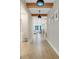 Hallway with view to the living room boasting tile floors and neutral paint at 2161 Gold Dust Dr, Minneola, FL 34715