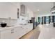 Modern kitchen with white cabinets, stainless steel appliances, sleek countertops, and open layout at 2161 Gold Dust Dr, Minneola, FL 34715