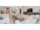 Open-concept living room showcases tile floors, modern decor, and a view of the kitchen at 2161 Gold Dust Dr, Minneola, FL 34715