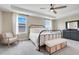 Bright main bedroom with a tray ceiling, ceiling fan, and comfortable furnishings at 2161 Gold Dust Dr, Minneola, FL 34715