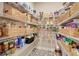 Walk-in pantry with wire shelving, organized storage baskets, and decorative tile flooring at 2161 Gold Dust Dr, Minneola, FL 34715