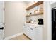 Organized pantry with open wood shelving, white cabinets, and stylish storage solutions at 2161 Gold Dust Dr, Minneola, FL 34715