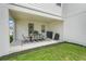 Covered outdoor patio with dining table, chairs, and a grill at 2161 Gold Dust Dr, Minneola, FL 34715