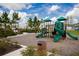 Community playground features green slides and covered play areas for outdoor fun at 2161 Gold Dust Dr, Minneola, FL 34715