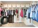 Organized walk-in closet with ample hanging space and storage containers at 2161 Gold Dust Dr, Minneola, FL 34715