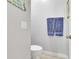 Modern bathroom with a toilet and fresh blue towels near a door to the outside at 233 Largovista Dr, Oakland, FL 34787