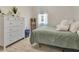 Cozy bedroom with natural light, white dresser, and comfortable furnishings at 233 Largovista Dr, Oakland, FL 34787
