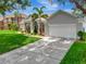 Charming single-Gathering home with a well-manicured lawn, lush landscaping, and a two-car garage at 233 Largovista Dr, Oakland, FL 34787