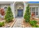 Close-up of the home's inviting entryway, framed by beautiful landscaping and rock border at 233 Largovista Dr, Oakland, FL 34787