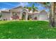 Inviting single-Gathering home with manicured lawn, elegant architectural details, and lush tropical landscaping at 233 Largovista Dr, Oakland, FL 34787
