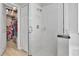 Bright shower with glass door and white tiles with an open closet to the side at 233 Largovista Dr, Oakland, FL 34787