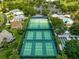 Aerial view showcasing community tennis and pickleball courts and a pool at 2450 Merida Cir, The Villages, FL 32162