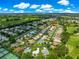 Elevated view of neighborhood with winding roads and lush lawns nestled in a golf course community at 2450 Merida Cir, The Villages, FL 32162