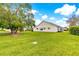 Spacious yard with lush green grass surrounding the house at 2450 Merida Cir, The Villages, FL 32162