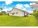 Well-maintained backyard with lush green lawn and exterior window shades at 2450 Merida Cir, The Villages, FL 32162