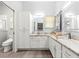 Bright bathroom boasts double sinks, granite counters, and a walk-in shower at 2450 Merida Cir, The Villages, FL 32162