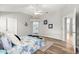 Bright bedroom features a ceiling fan, wood-look flooring, and two entryways at 2450 Merida Cir, The Villages, FL 32162