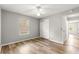 Bedroom featuring wood floors, a ceiling fan, a window with blinds, and a closet at 2450 Merida Cir, The Villages, FL 32162