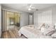 Cozy bedroom featuring wood floors, ceiling fan, sliding glass door and closet at 2450 Merida Cir, The Villages, FL 32162