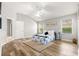 Bright bedroom features a ceiling fan, wood-look flooring, and two windows at 2450 Merida Cir, The Villages, FL 32162