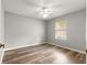 Empty bedroom featuring wood floors, a ceiling fan, and a window with blinds at 2450 Merida Cir, The Villages, FL 32162
