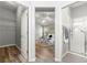 Bedroom view into closet and bathroom shower featuring wood look floors at 2450 Merida Cir, The Villages, FL 32162