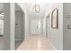 Welcoming foyer with neutral walls, tile flooring, and decorative light fixture at 2450 Merida Cir, The Villages, FL 32162