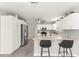 Bright kitchen featuring white cabinets, stainless steel appliances, and a stylish backsplash at 2450 Merida Cir, The Villages, FL 32162