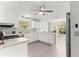 Bright kitchen with white cabinets, modern appliances, and a stylish backsplash, adjacent to a cozy breakfast nook at 2450 Merida Cir, The Villages, FL 32162