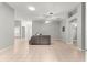 Open concept living room with tile floors, a cozy sectional sofa, and views into the kitchen and dining area at 2450 Merida Cir, The Villages, FL 32162