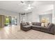 Inviting living room with a comfortable sectional sofa and a view of the adjacent dining area at 2450 Merida Cir, The Villages, FL 32162