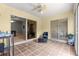 Inviting patio featuring tile floors, seating, and sliding glass doors leading indoors at 2450 Merida Cir, The Villages, FL 32162