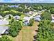 A high angle showing a neighborhood featuring lush lawns and mature trees surrounding lovely homes at 25400 Waterbrook Ct, Leesburg, FL 34748
