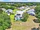 Scenic aerial view of a home with a screened-in pool and well-manicured lawn in a tranquil neighborhood at 25400 Waterbrook Ct, Leesburg, FL 34748